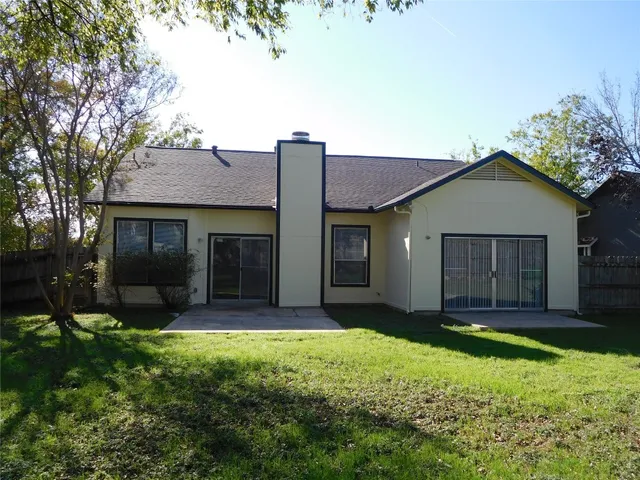 a view of a backyard with a small cabin and a chair