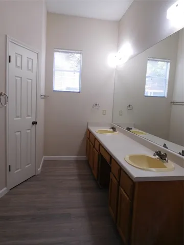 a bathroom with a sink double vanity and a mirror