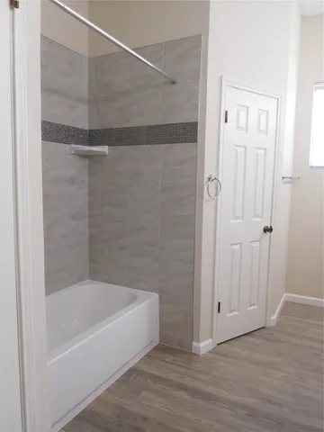 a view of a house with a yard and large tree