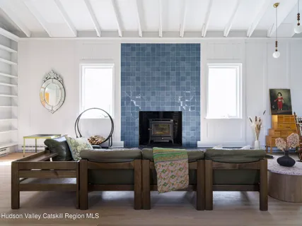 a living room with furniture a fireplace and a table