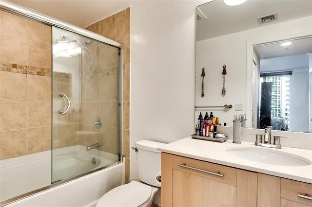 a bathroom with a glass shower door