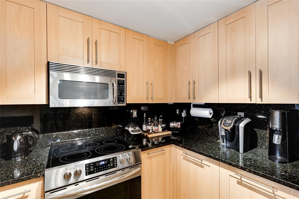 511 Southeast 5th Avenue, Unit 1022 Fort Lauderdale, FL 33301 - Photo 4 of 67 a kitchen with granite countertop a stove and a microwave
