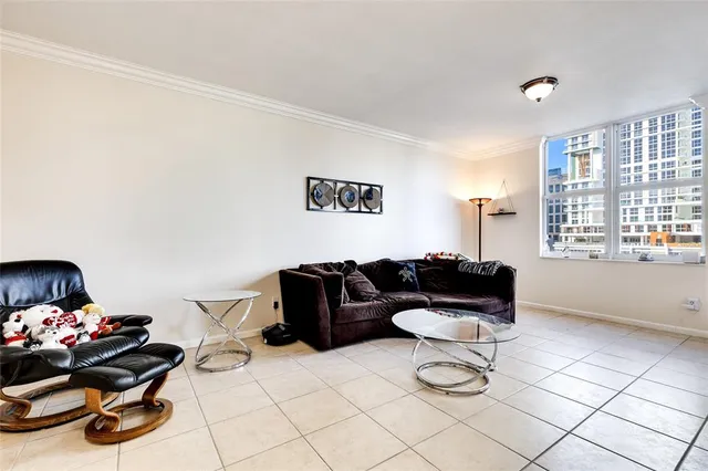a living room with furniture a couch and a potted plant