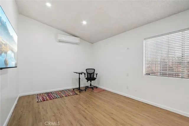 a view of a room with wooden floor and bench