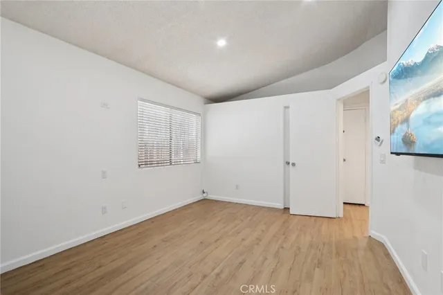 a view of a room with wooden floor and white walls
