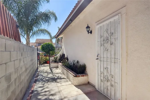 a hallway with a couch and a potted plant
