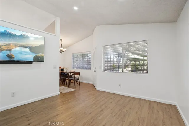 a view of a room with wooden floor and furniture
