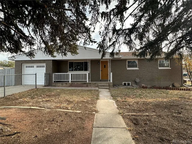 a front view of a house with a space and trees