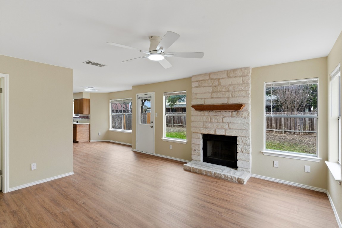 3900 Lemos Drive Austin, TX 78728 - Photo 14 of 35 a view of an empty room with wooden floor fireplace and a window