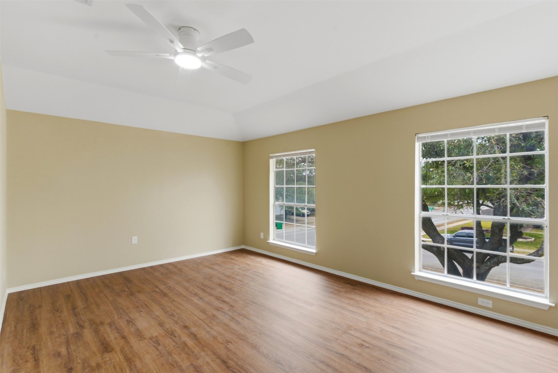 3900 Lemos Drive Austin, TX 78728 - Photo 15 of 35 a view of an empty room with a window and wooden floor