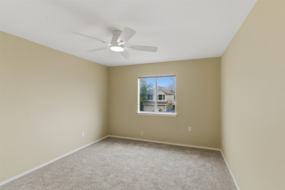 3900 Lemos Drive Austin, TX 78728 - Photo 18 of 35 an empty room with a window and ceiling fan