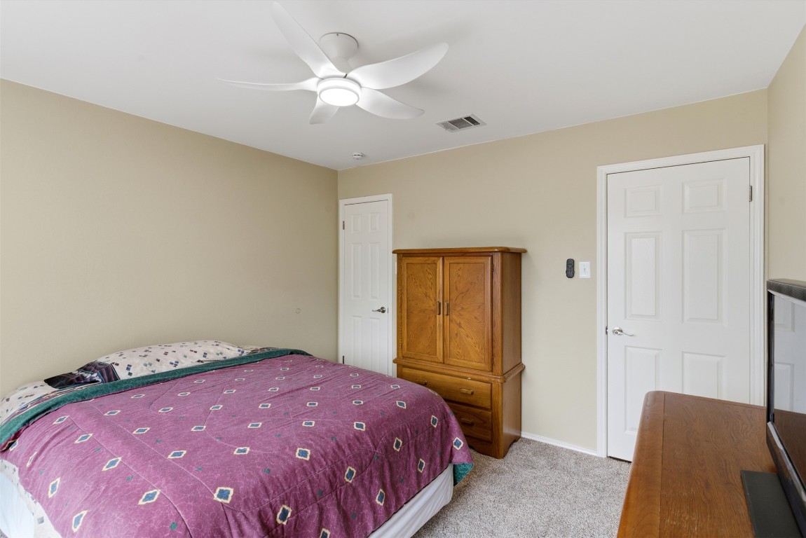 3900 Lemos Drive Austin, TX 78728 - Photo 21 of 35 a bedroom with a bed and a chandelier