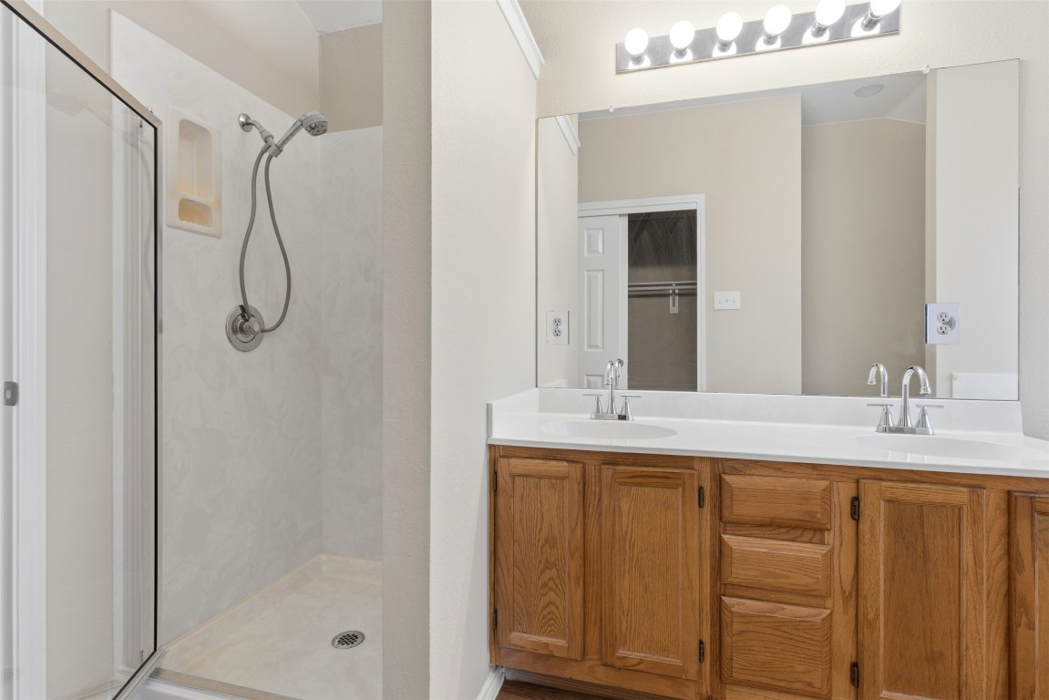 3900 Lemos Drive Austin, TX 78728 - Photo 27 of 35 a bathroom with a granite countertop sink two mirror and shower