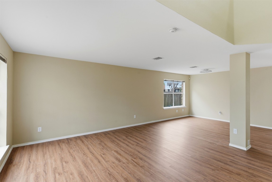 3900 Lemos Drive Austin, TX 78728 - Photo 5 of 35 an empty room with wooden floor and windows