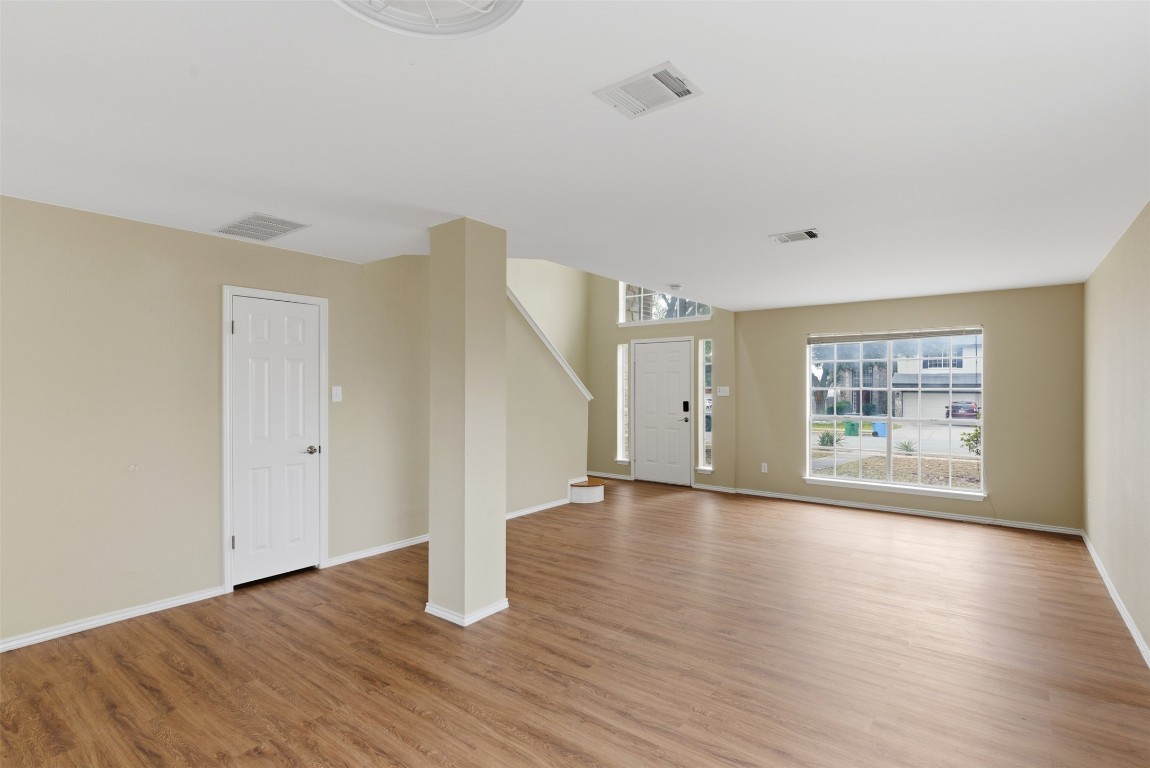 3900 Lemos Drive Austin, TX 78728 - Photo 6 of 35 a view of an empty room with wooden floor and a window