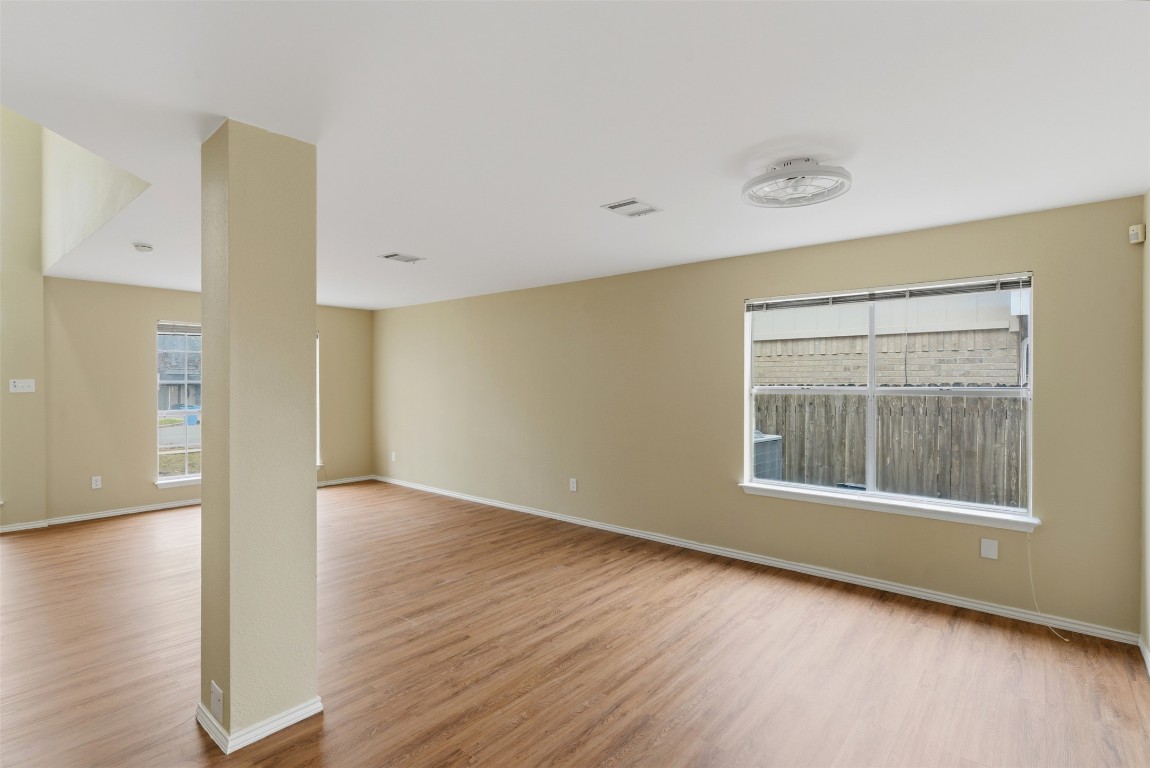 3900 Lemos Drive Austin, TX 78728 - Photo 7 of 35 an empty room with wooden floor and windows