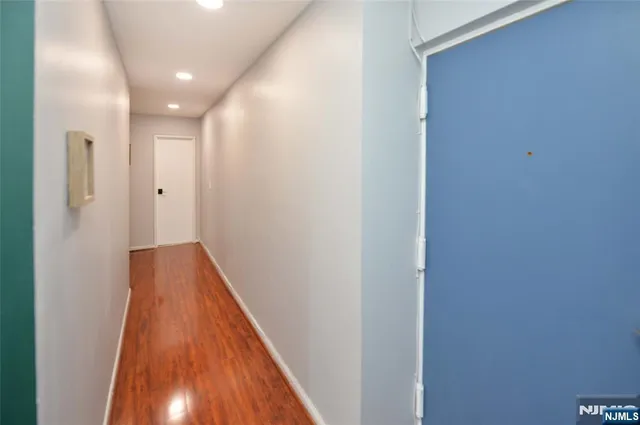 a view of a hallway with wooden floor