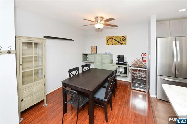 a view of a dining room with furniture a chandelier and wooden floor