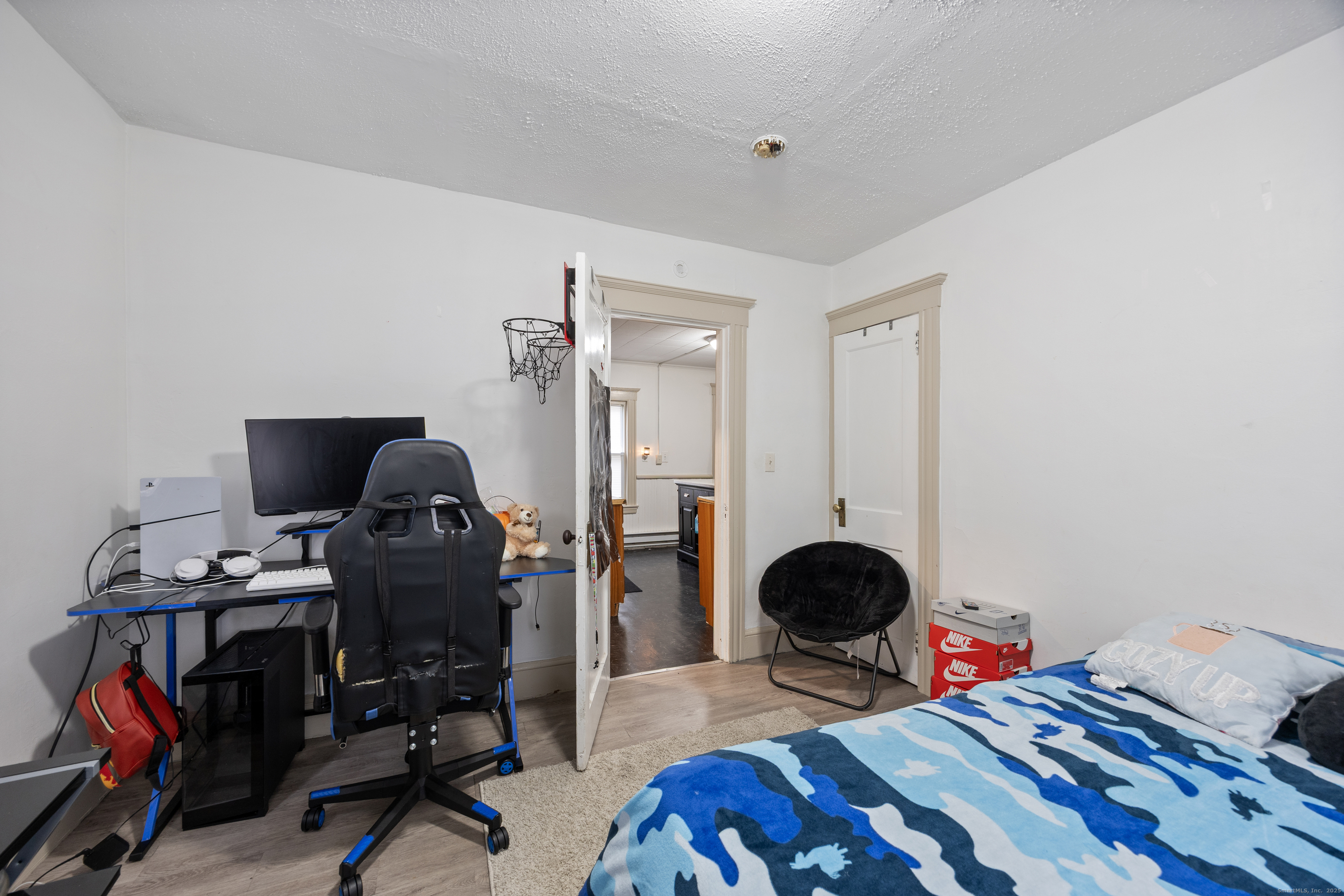 29 Berry Street Torrington, CT 06790 - Photo 13 of 31 a bedroom with a bed and a chandelier