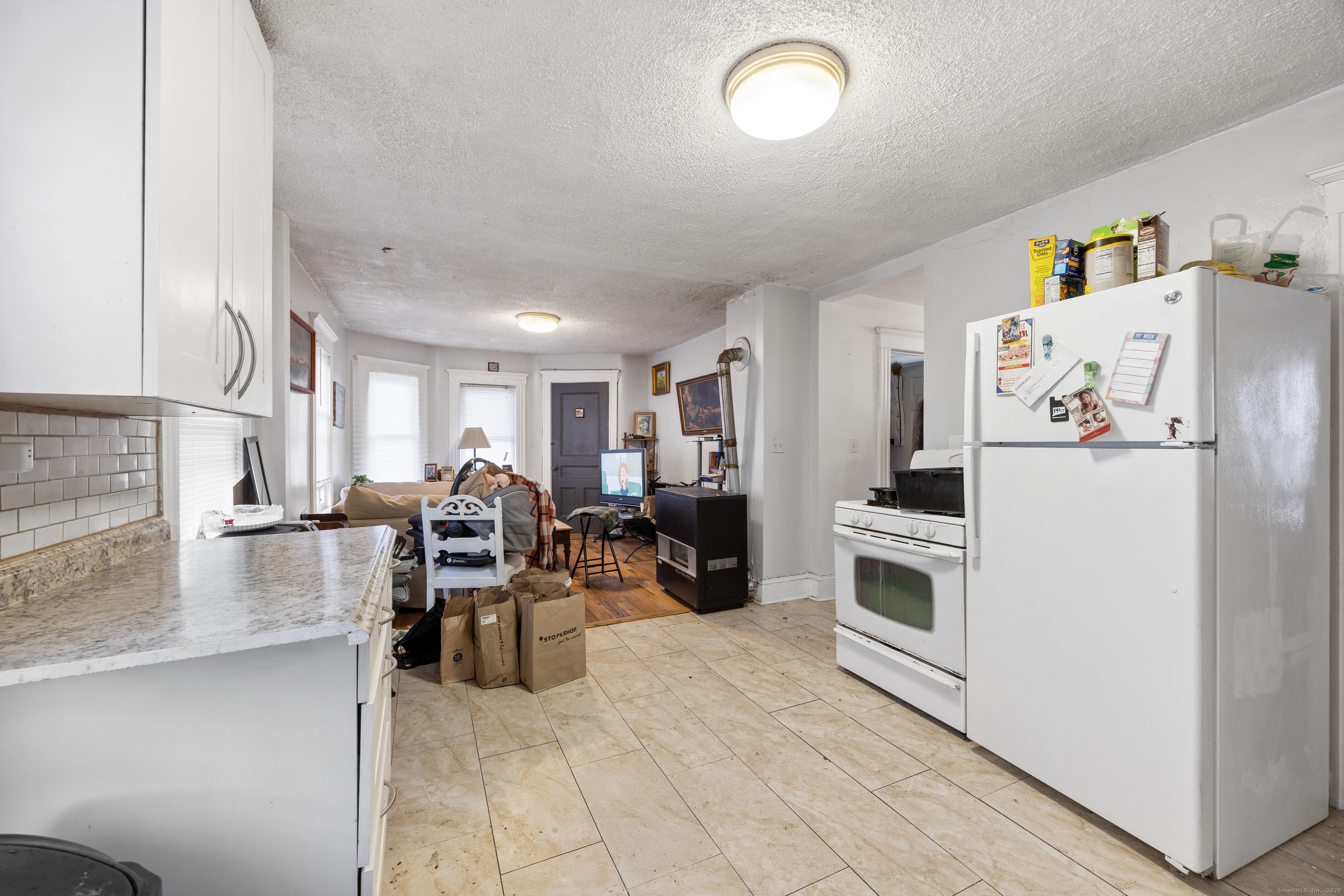 29 Berry Street Torrington, CT 06790 - Photo 16 of 31 a large white kitchen with cabinets
