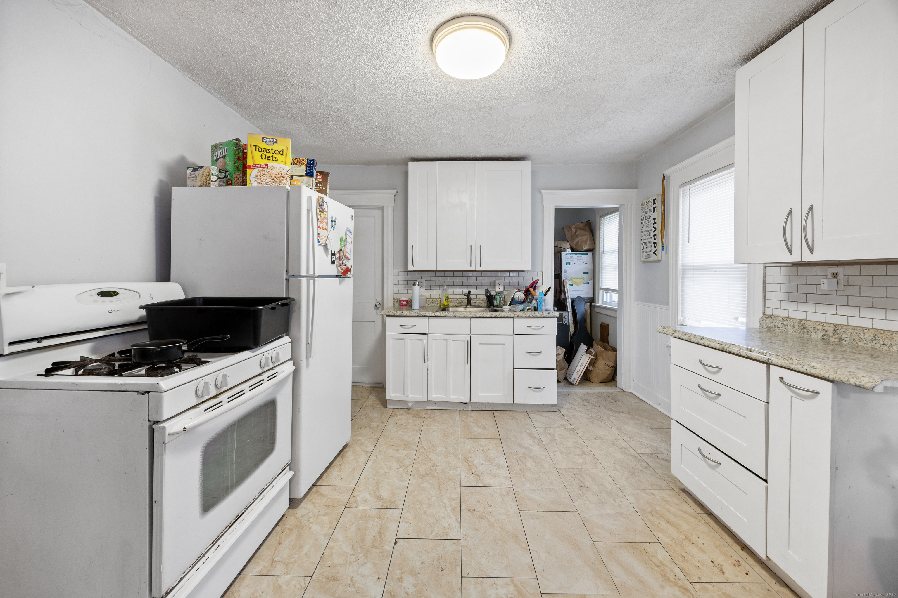 29 Berry Street Torrington, CT 06790 - Photo 17 of 31 a kitchen with a stove top oven sink and cabinets