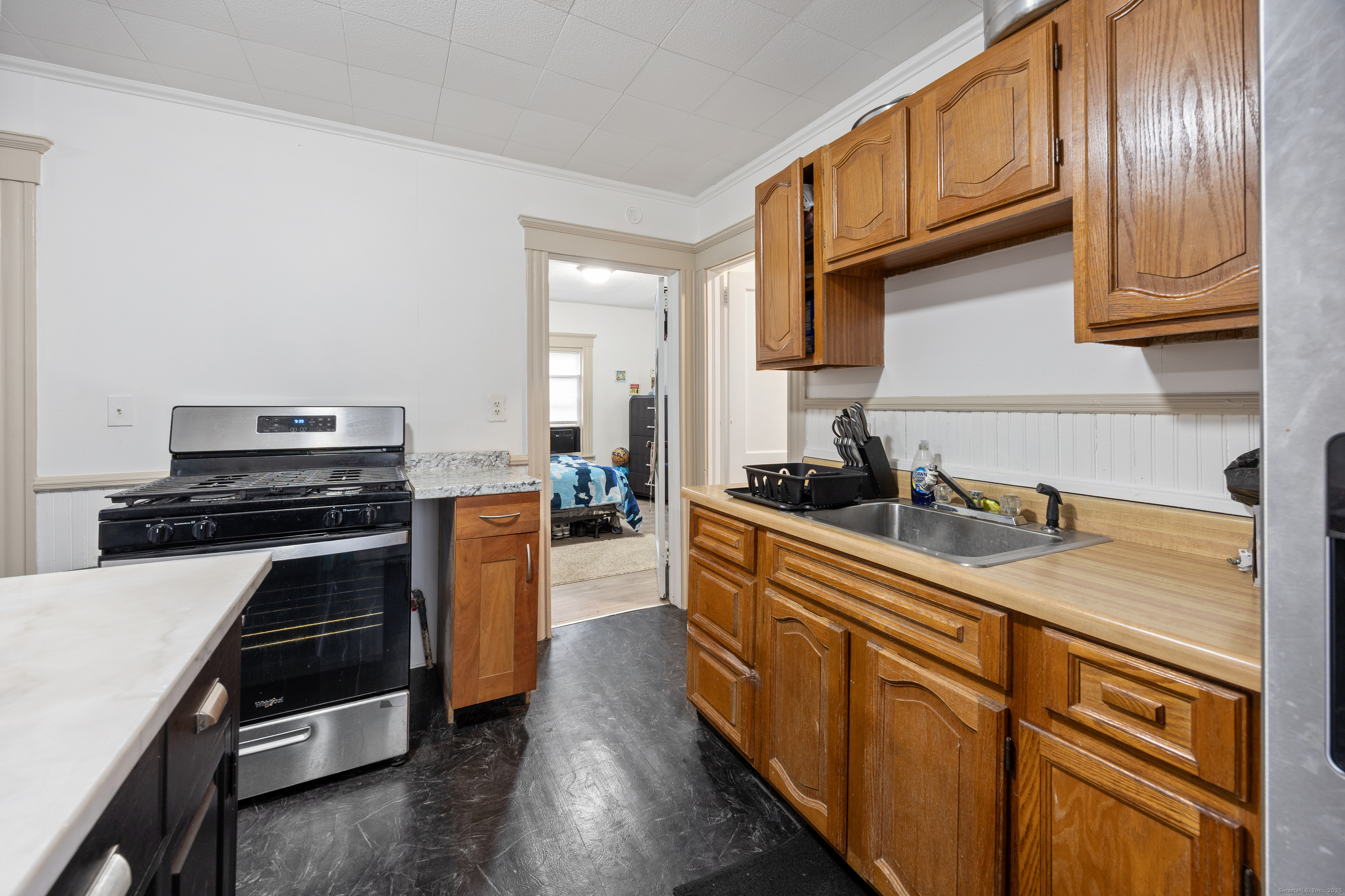 29 Berry Street Torrington, CT 06790 - Photo 6 of 31 a kitchen with granite countertop stainless steel appliances and wooden cabinets