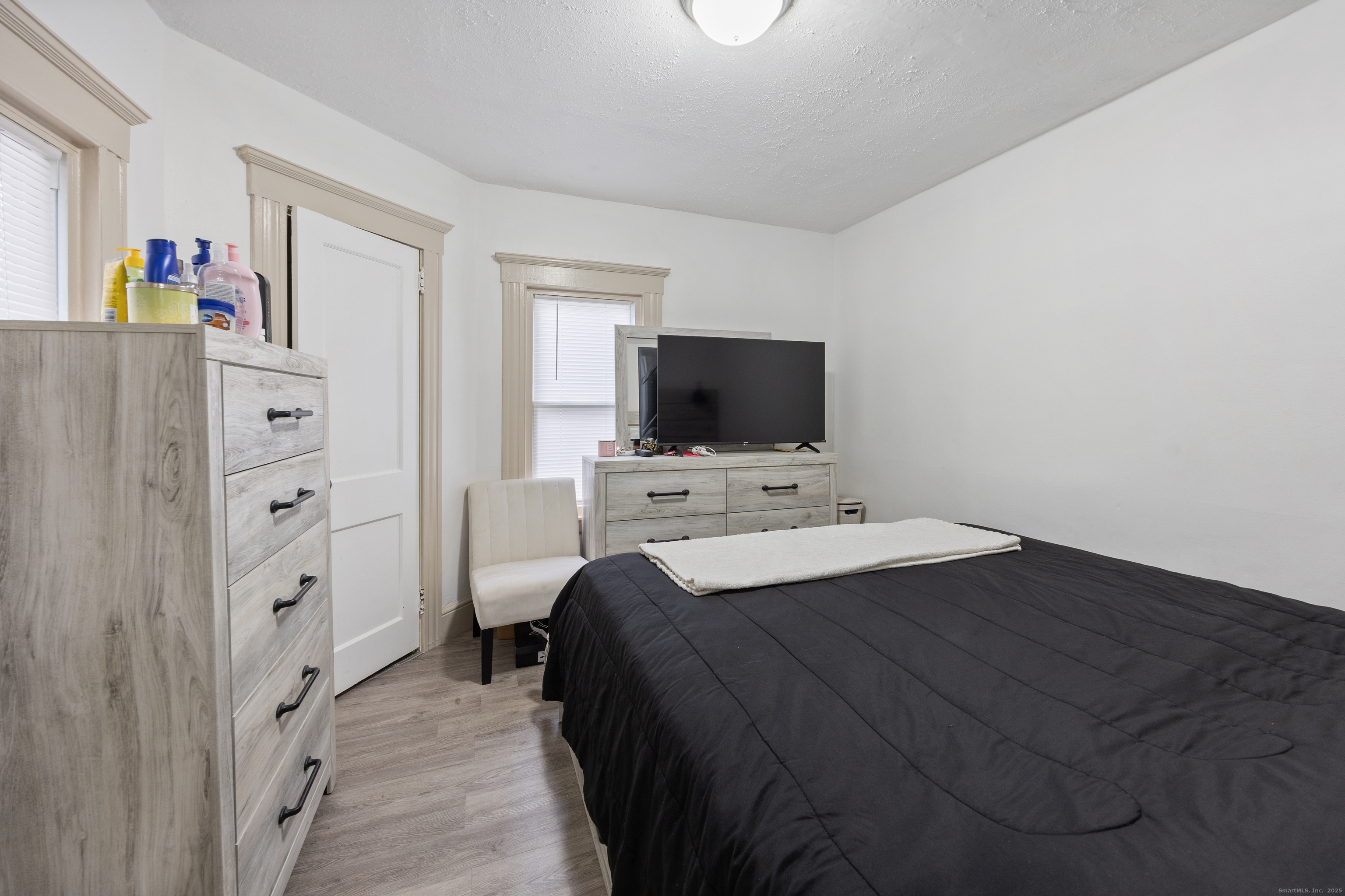 29 Berry Street Torrington, CT 06790 - Photo 9 of 31 a bedroom with a bed and a flat screen tv