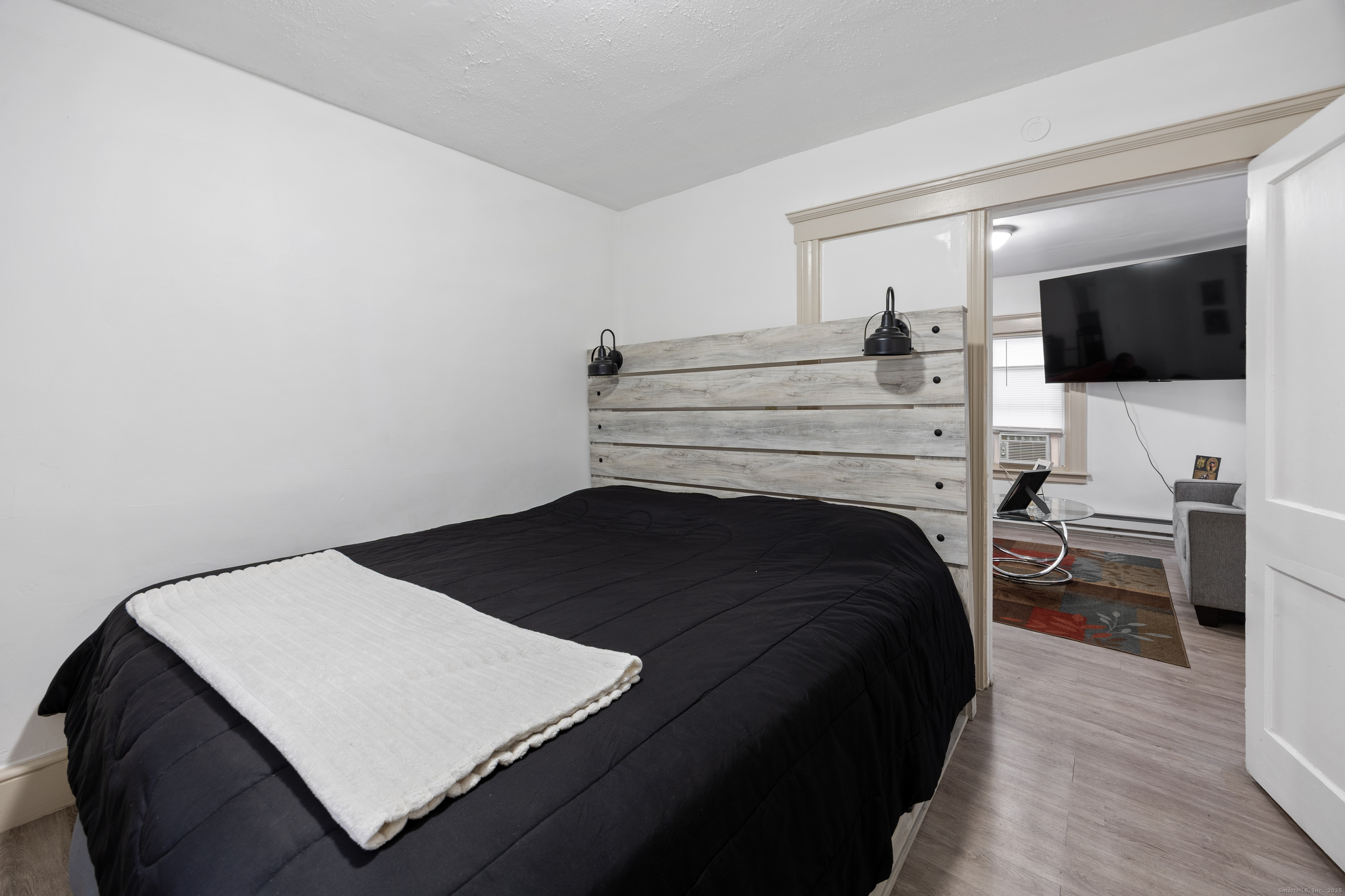 29 Berry Street Torrington, CT 06790 - Photo 10 of 31 a bedroom with a bed and a flat screen tv