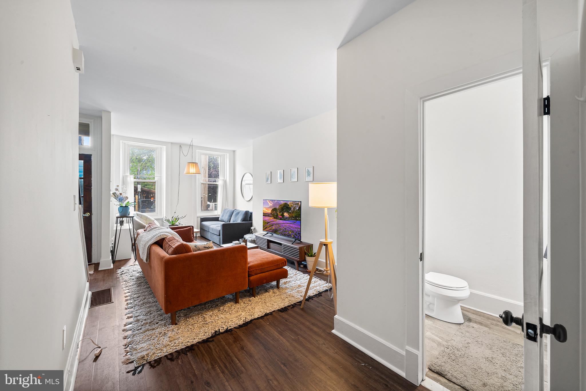 107 Master Street Philadelphia, PA 19122 - Photo 8 of 24 a living room with furniture and a wooden floor