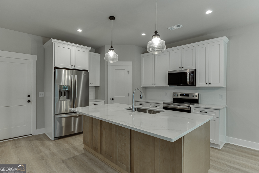 110 Rains Road Jefferson, GA 30549 - Photo 14 of 43 a kitchen with cabinets and stainless steel appliances