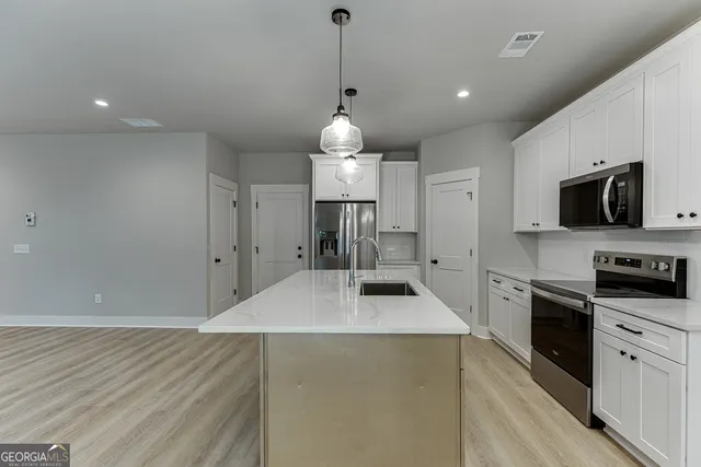 a kitchen with granite countertop a stove and a sink