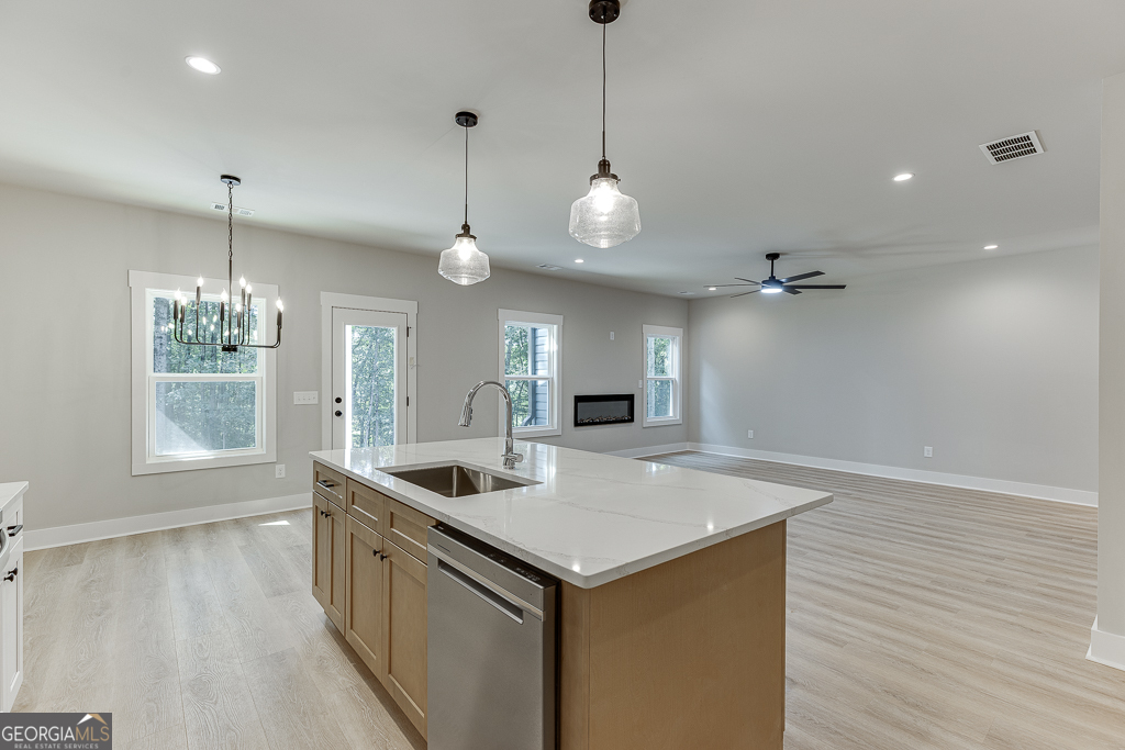 110 Rains Road Jefferson, GA 30549 - Photo 17 of 43 a open kitchen with stainless steel appliances granite countertop a sink a refrigerator and a wooden floor