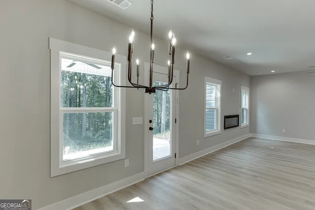 a view of a room with wooden floor and a large window
