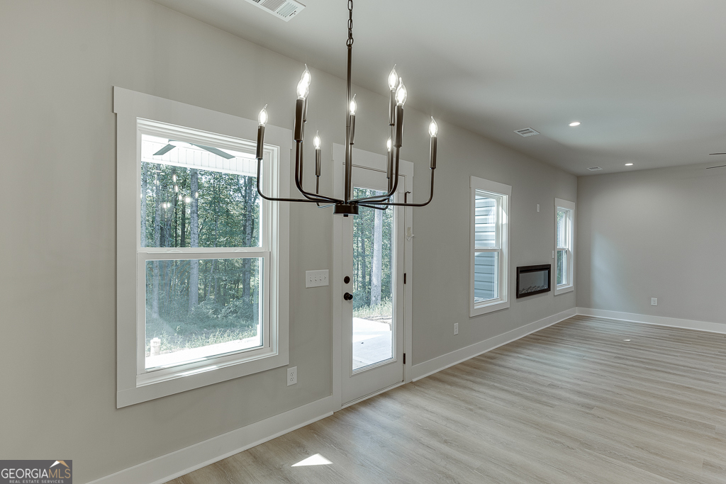 110 Rains Road Jefferson, GA 30549 - Photo 20 of 43 a view of a room with wooden floor and a large window
