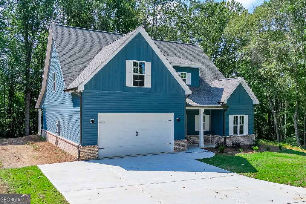 110 Rains Road Jefferson, GA 30549 - Photo 2 of 43 a front view of a house with a garden and yard
