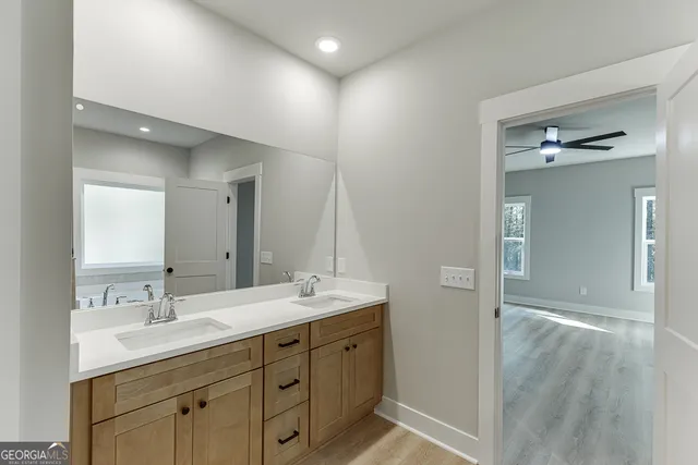 a bathroom with a double vanity sink and mirror