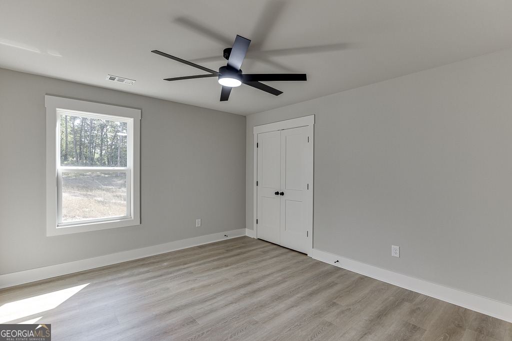 110 Rains Road Jefferson, GA 30549 - Photo 33 of 43 a view of an empty room with wooden floor and a window