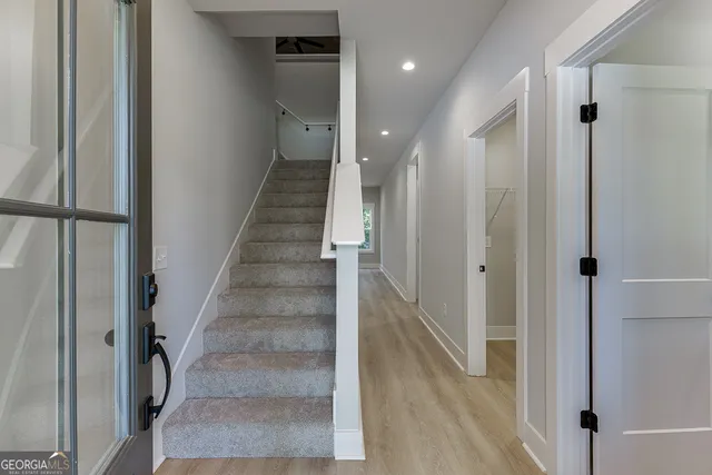 a view of entryway and hall with wooden floor