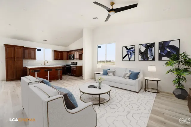 a living room with furniture and kitchen view