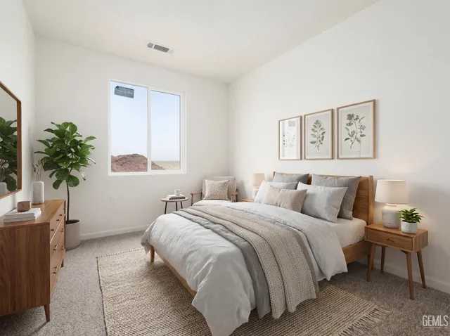 a bed room with a bed and a potted plant