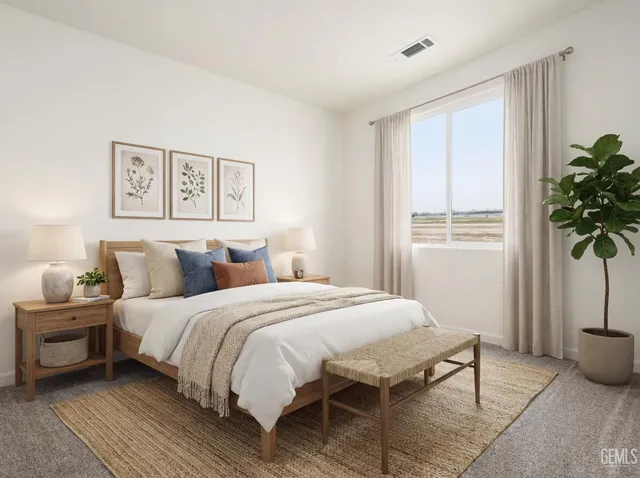 a bedroom with a bed table and a window