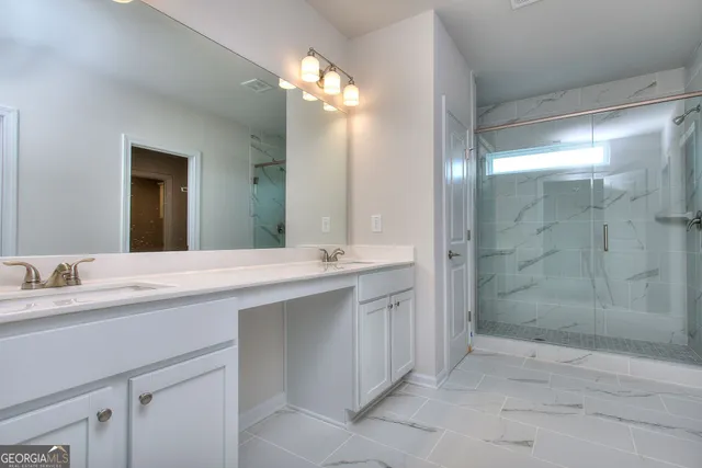 a bathroom with a double vanity sink mirror and shower