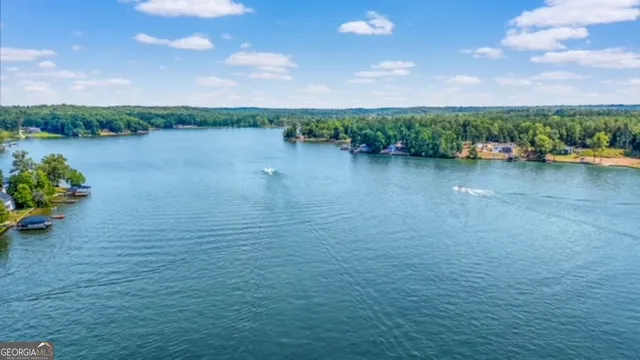 a view of a lake with houses in the back