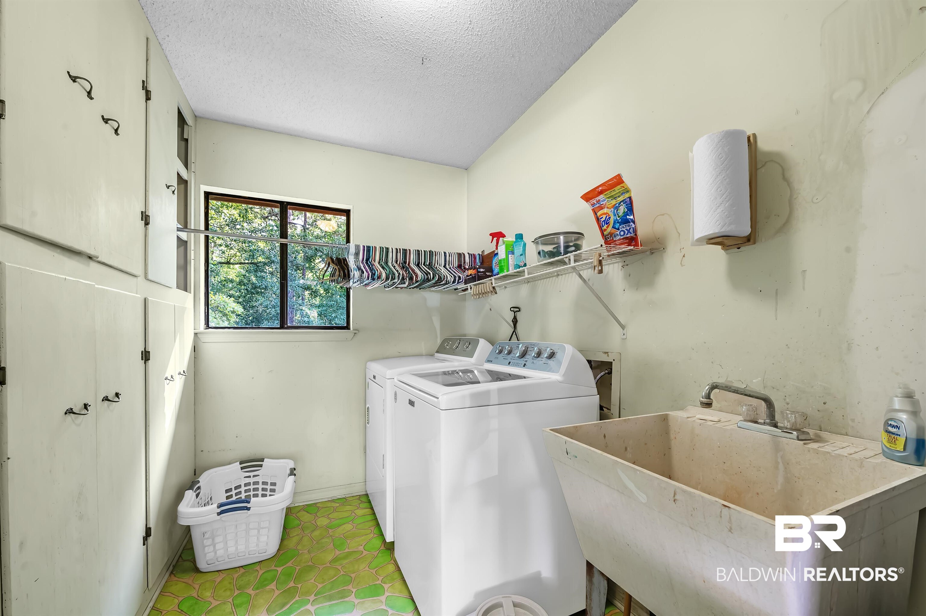104 James Circle Daphne, AL 36526 - Photo 62 of 62 Clothes washing area with washing machine and dryer, sink, and a textured ceiling