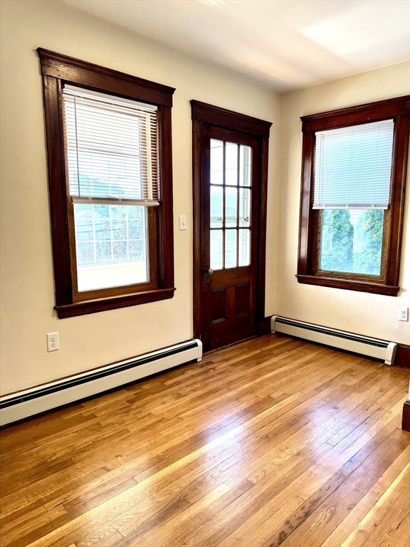 57 Winthrop Road, Unit 2 Everett, MA 02149 - Photo 11 of 15 a view of an empty room with wooden floor and a window