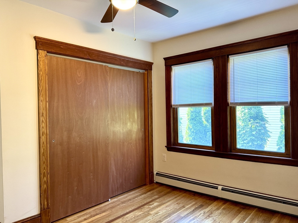57 Winthrop Road, Unit 2 Everett, MA 02149 - Photo 12 of 15 an empty room with wooden floor and windows