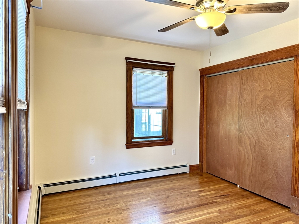 57 Winthrop Road, Unit 2 Everett, MA 02149 - Photo 13 of 15 an empty room with wooden floor fan and windows