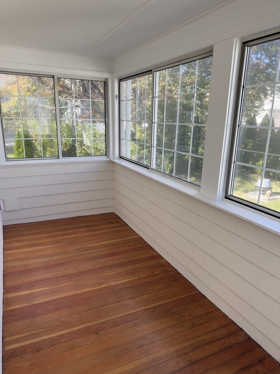 57 Winthrop Road, Unit 2 Everett, MA 02149 - Photo 5 of 15 a view of an empty room with wooden floor and a window