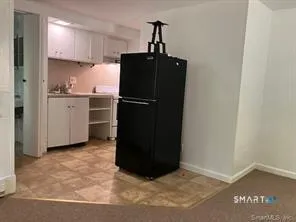 a kitchen with a refrigerator and cabinets