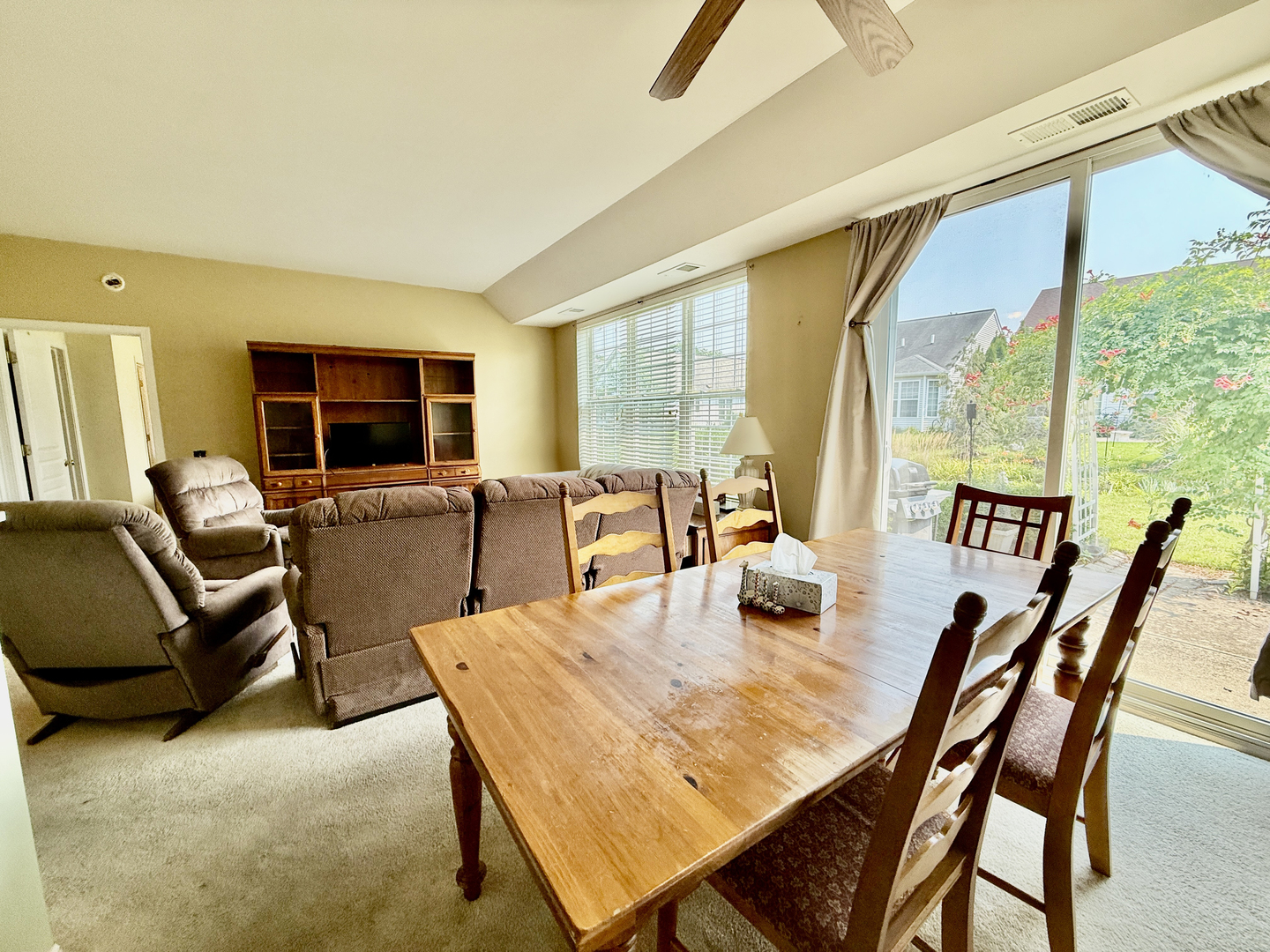 13455 Nealy Road Huntley, IL 60142 - Photo 15 of 16 a dining room with furniture a flat screen tv and a large window